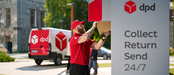 DPD courier is delivering packages to a locker for customers.
